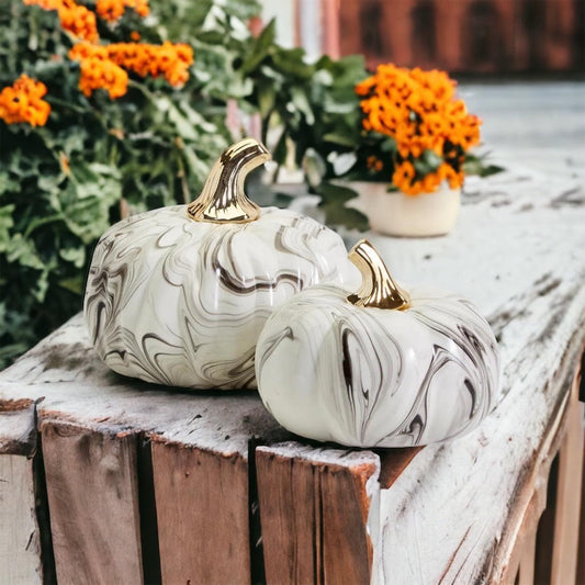 Black and white marbled gourd used as a luxury coffee table decor accent in a modern living room.