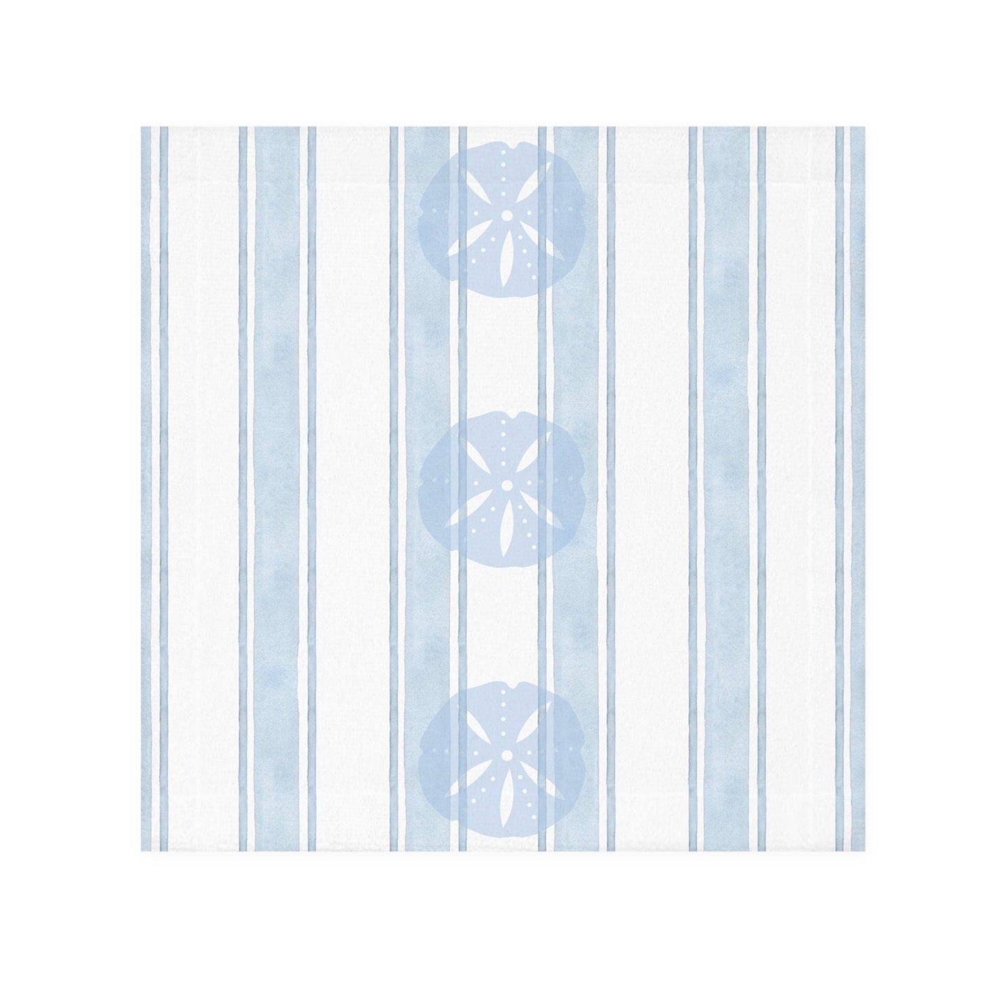 Beach-inspired bathroom decor featuring a sand dollar patterned towel hanging against a soft coastal wall.