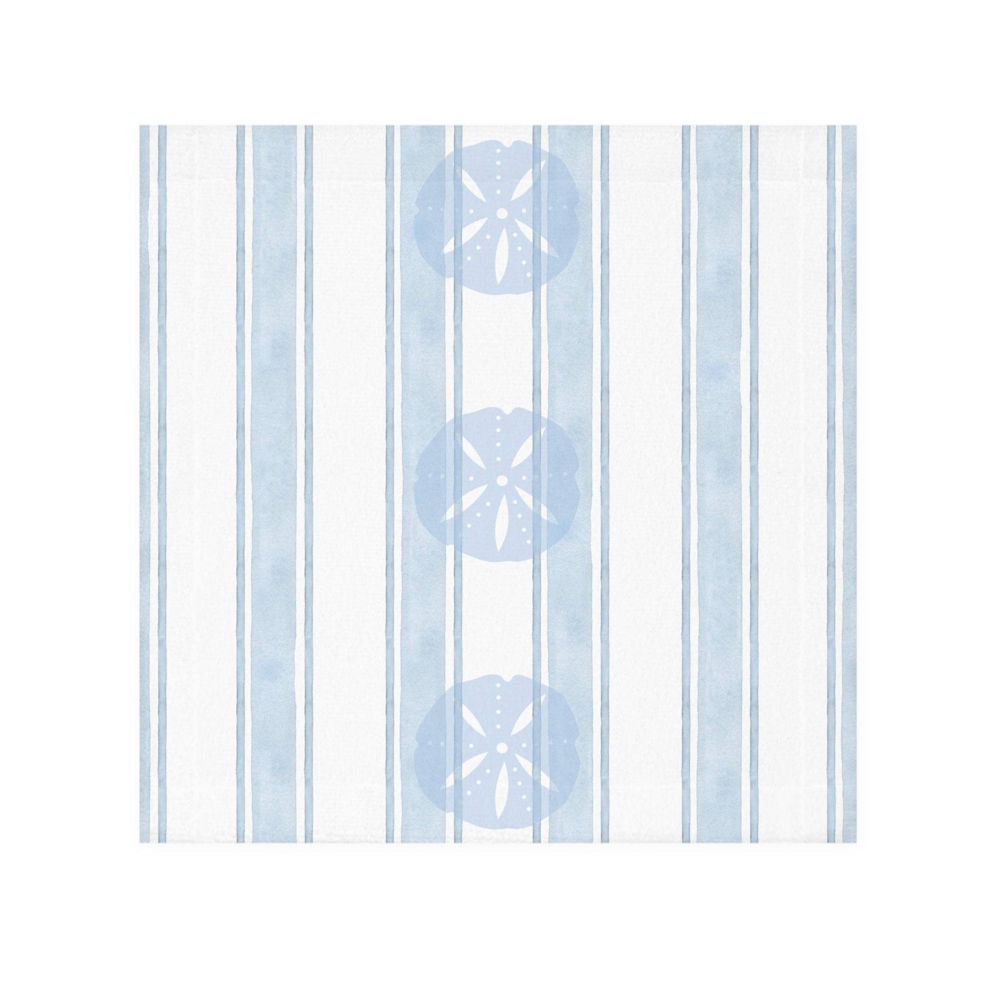 Beach-inspired bathroom decor featuring a sand dollar patterned towel hanging against a soft coastal wall.