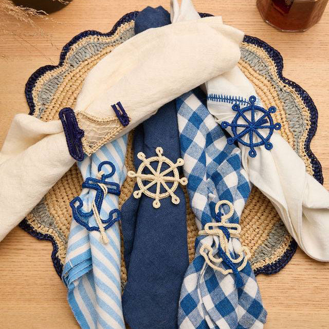 Styled image of the anchor napkin ring set as a thoughtful beach house gift for a host.