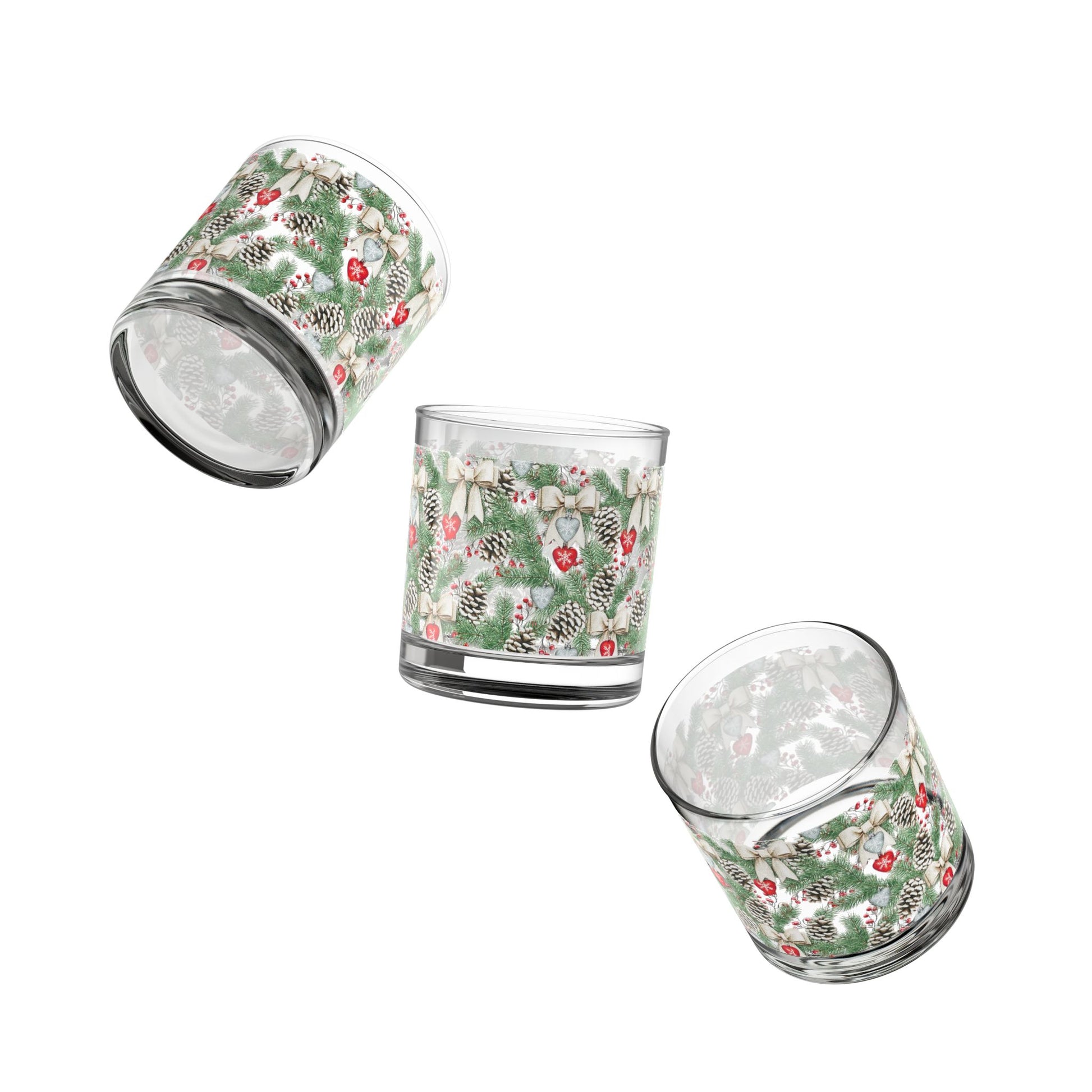 Close-up of a clear Christmas Rocks Glass featuring a detailed snowy pinecone and holly berry repeating pattern.