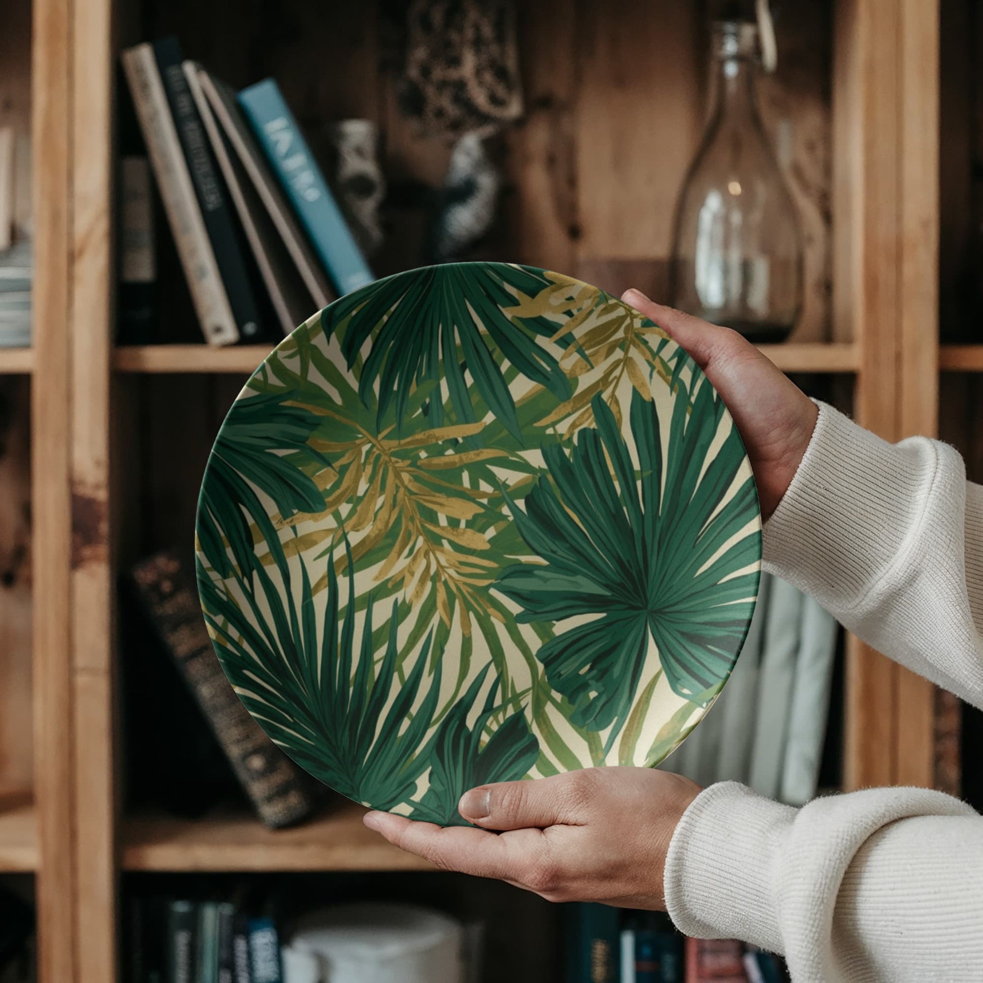 Close-up of the shatterproof luxury palm print plate being handled, demonstrating its durability for outdoor use.