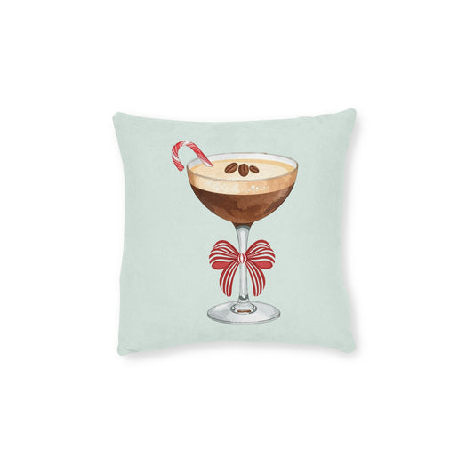 Decorative pillow with a cocktail design featuring a candy cane and bow on a light green background