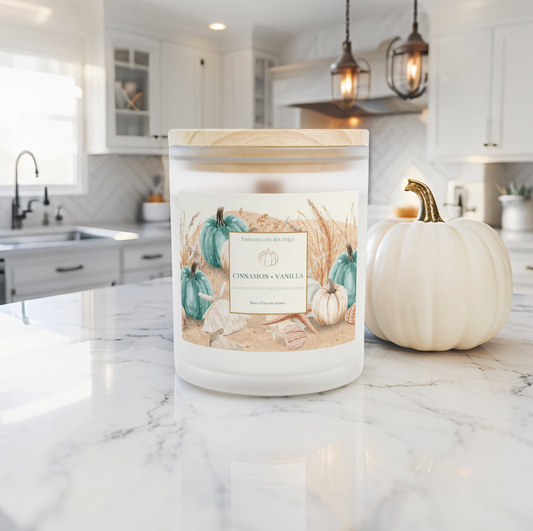 Fall coastal cinnamon vanilla candle on a coffee table in a luxury beach house.