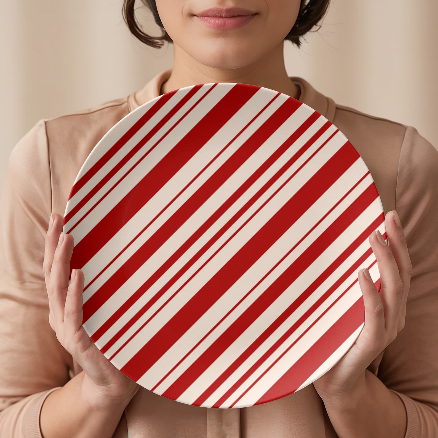 A stack of red striped farmhouse Christmas dinnerware plates, showcasing the 10 inch size.