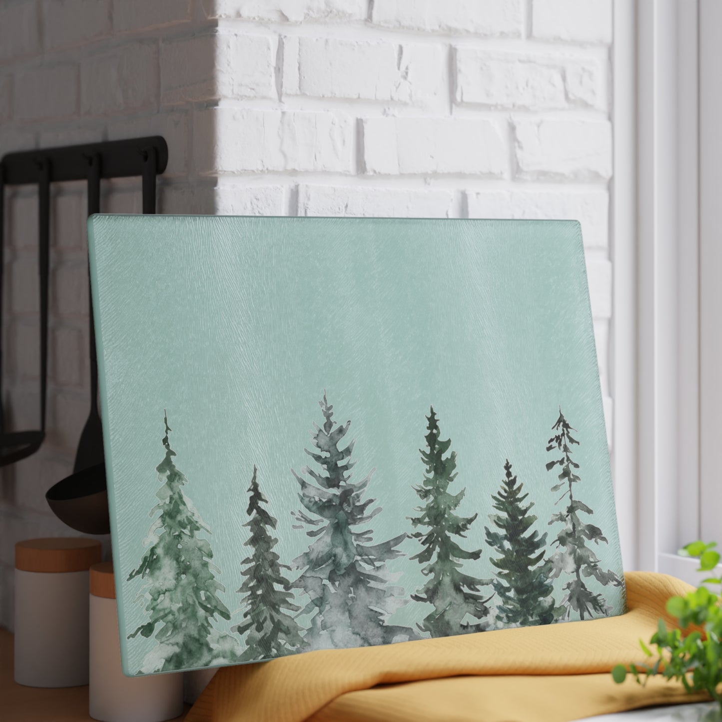 Festive glass charcuterie serving platter with evergreen tree artwork.