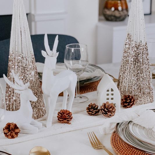 Elegant holiday tabletop centerpiece using a set of 3 neutral-colored cone decor trees.
