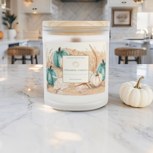 Hand-poured autumn candle in cinnamon vanilla fragrance with coastal-inspired design.