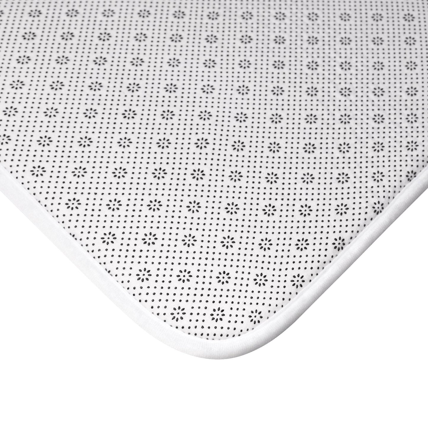 Minimalist white and beige seashell bath mat, offering a subtle coastal elegance