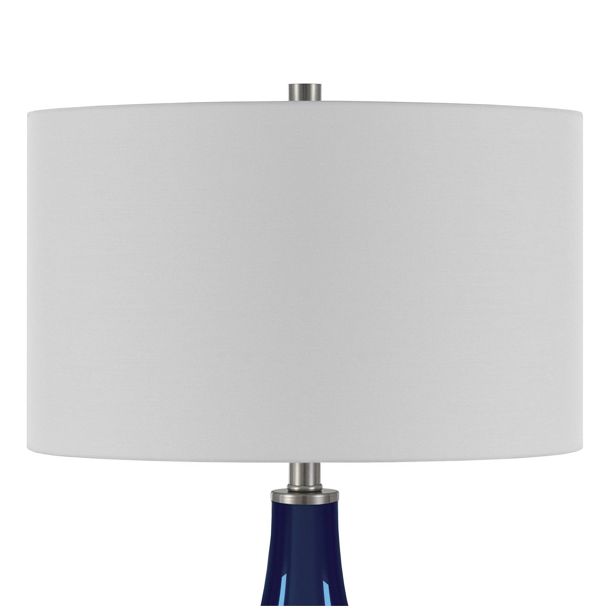 Modern navy blue gourd lamp providing ambient lighting in coastal home