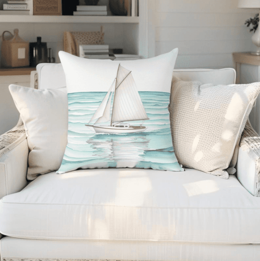 Minimalist nautical throw pillow featuring a sailboat design, styled for beach house decor.