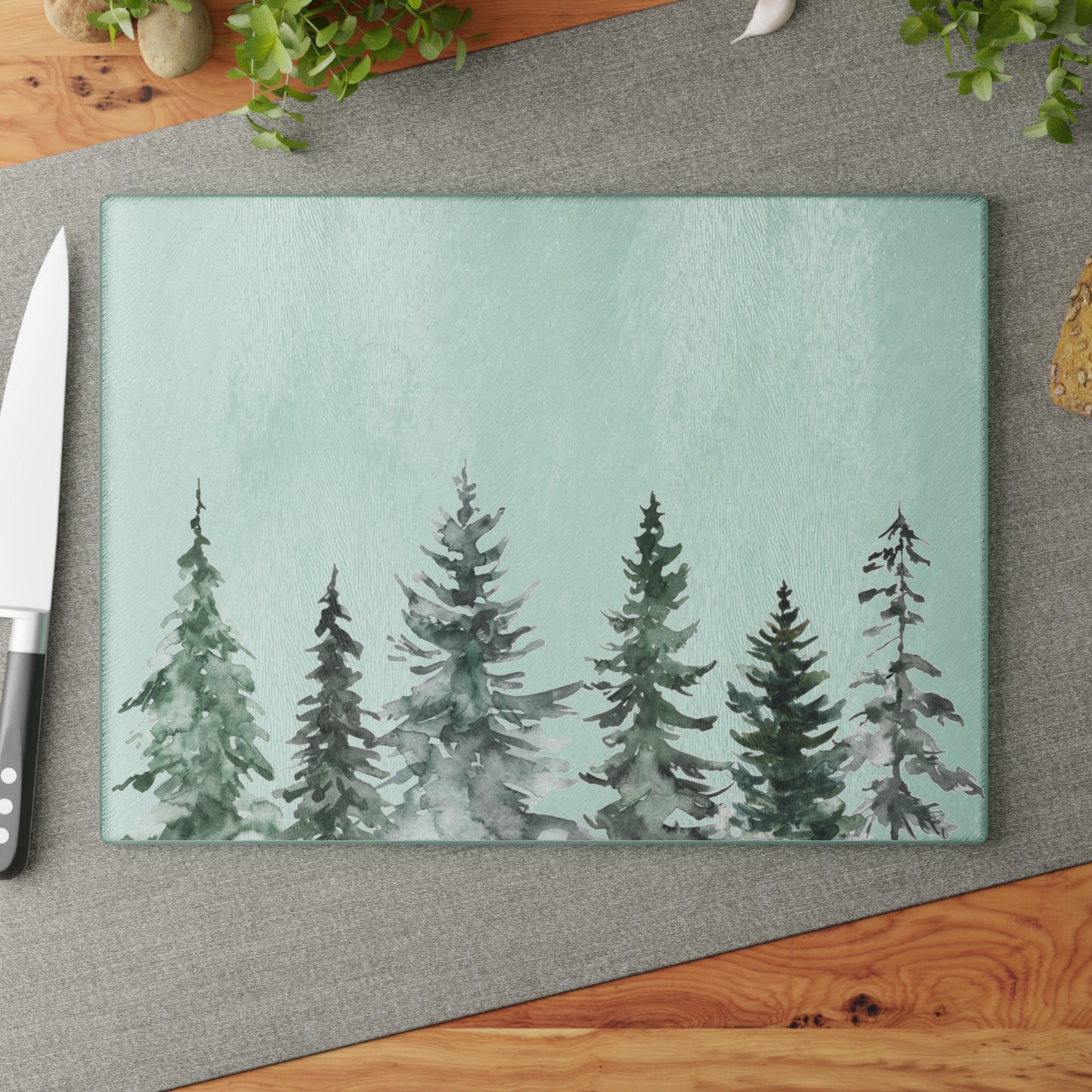 Watercolor pine tree glass cutting board and matching cocktail napkins holiday entertaining gift set.