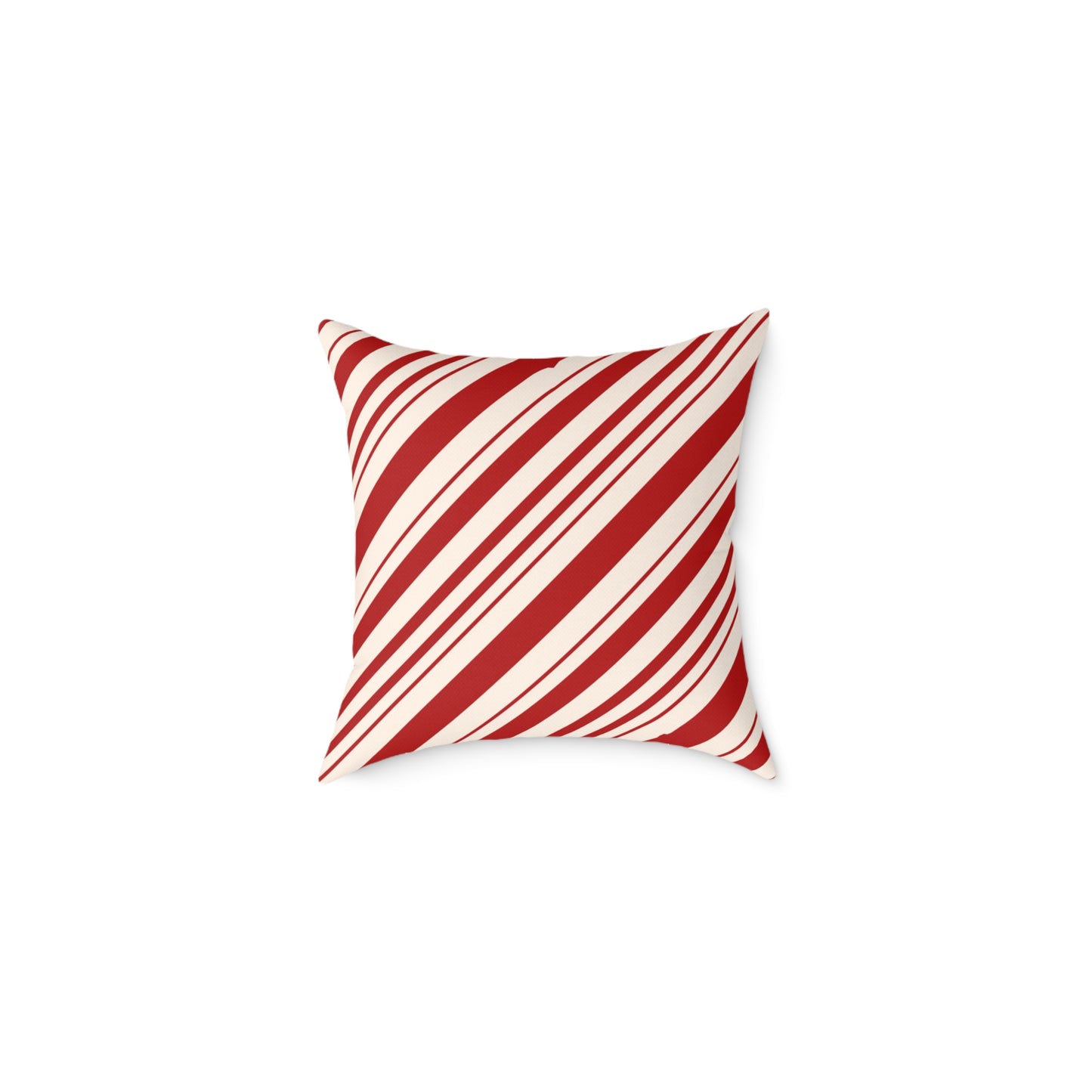 Red and white striped Christmas throw pillow styled on a cozy gray sofa with a holiday blanket.