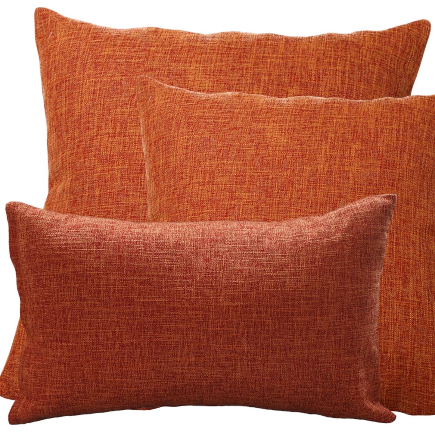 Decorative burnt orange accent pillows on a modern sofa, creating a cozy and elegant fall look.