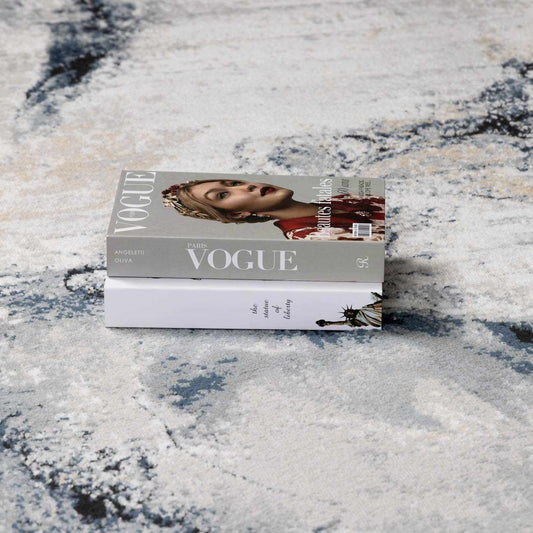 Close-up of the slate blue and navy tones blending into the gray background of the rug.