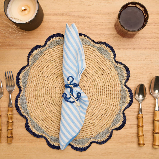 Handwoven raffia anchor napkin rings in blue and white on a dining table, set of 4.