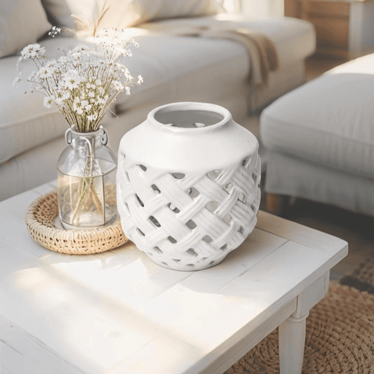 White ceramic vase with openwork lattice in beach-style shelf decor