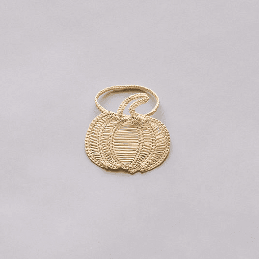 Close-up of handmade woven rattan texture on a pumpkin ring, used as boho fall table decor.