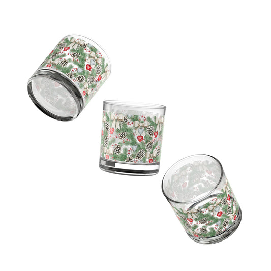 Close-up of a clear Christmas Rocks Glass featuring a detailed snowy pinecone and holly berry repeating pattern.
