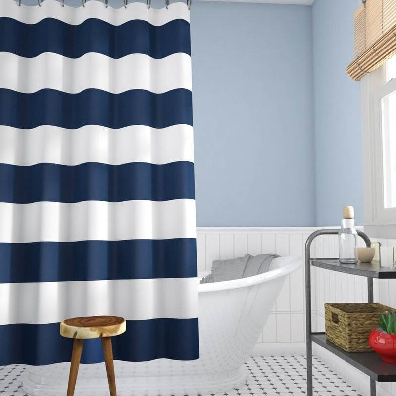 Ocean-inspired navy and white stripe curtain hanging in bathroom