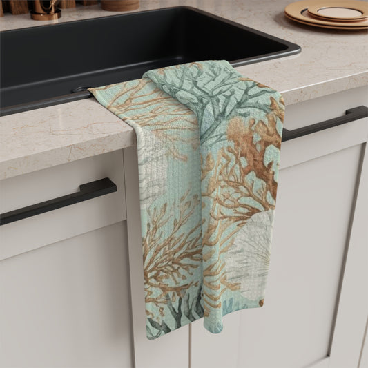 Coastal reef print kitchen towel with aqua coral and sea fan design, soft microfiber tea towel displayed in a modern coastal kitchen.