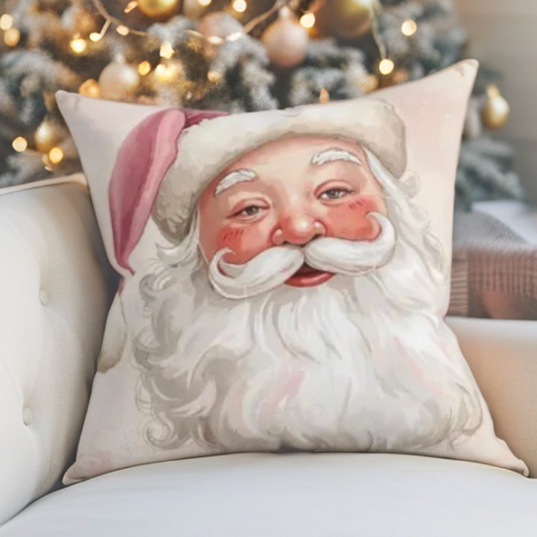 Cozy Pink Christmas Santa face accent pillow displayed on an armchair with glowing lights in the background.