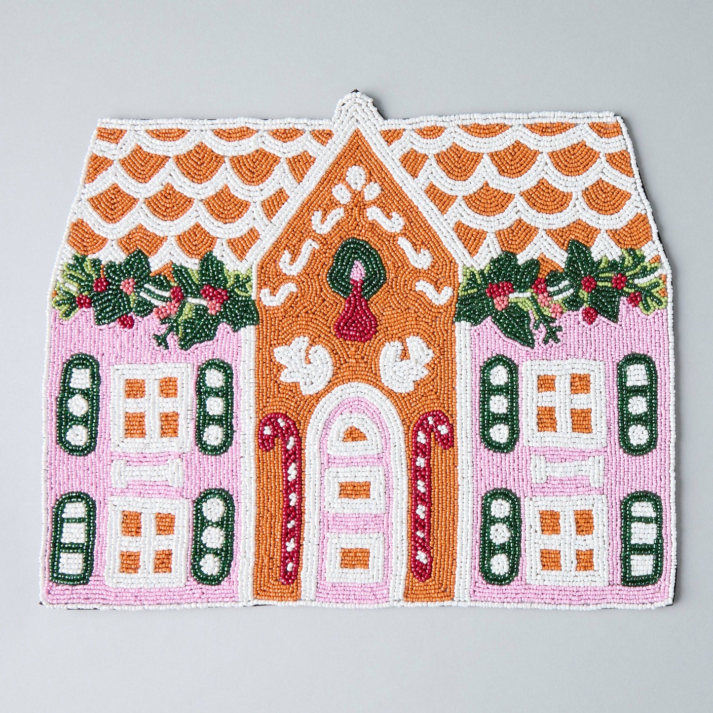 handcrafted gingerbread house beaded placemat on holiday table