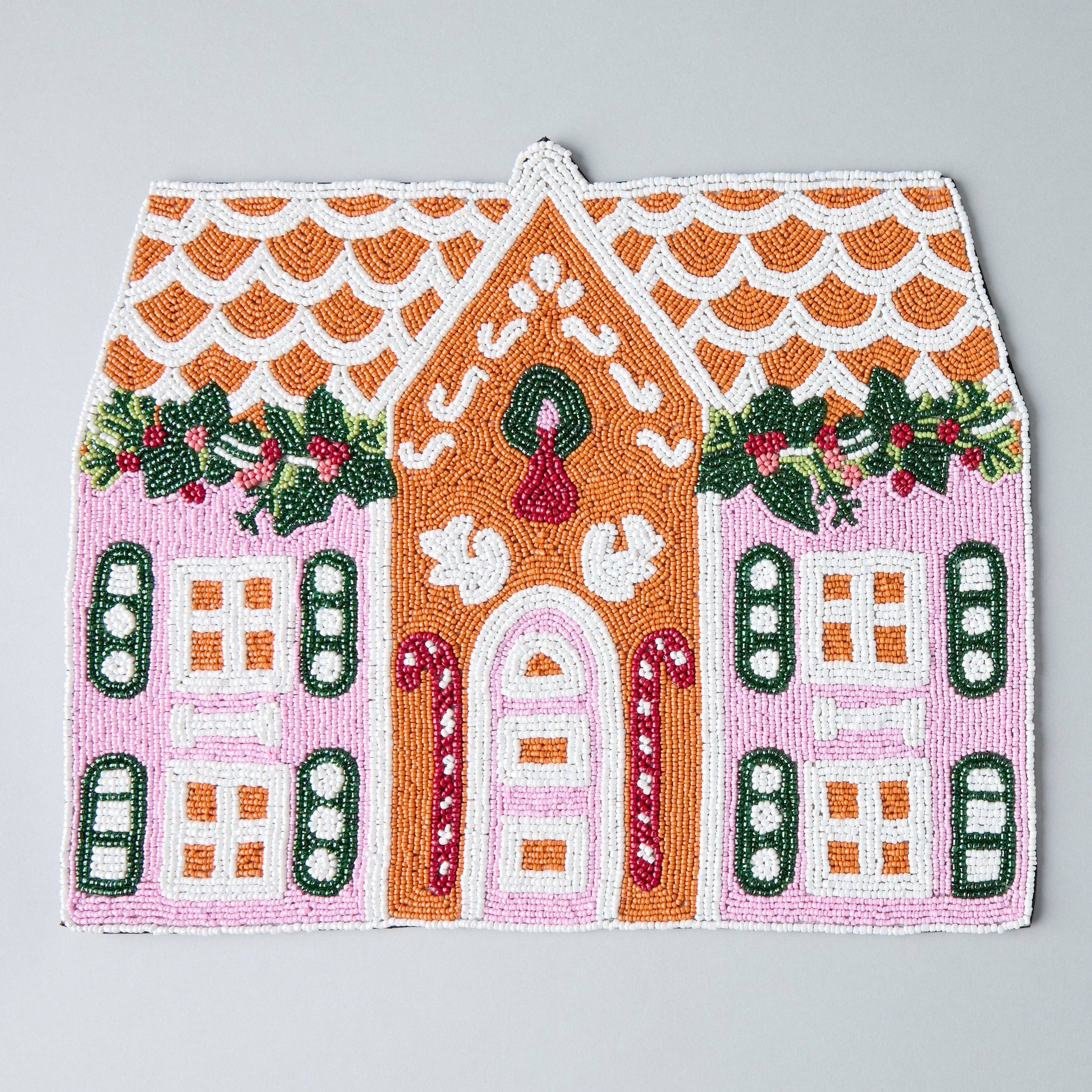 handcrafted gingerbread house beaded placemat on holiday table