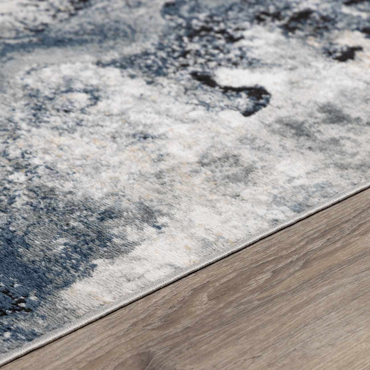 Modern low-pile rug displayed in a living room setting, showcasing its size and contemporary style.