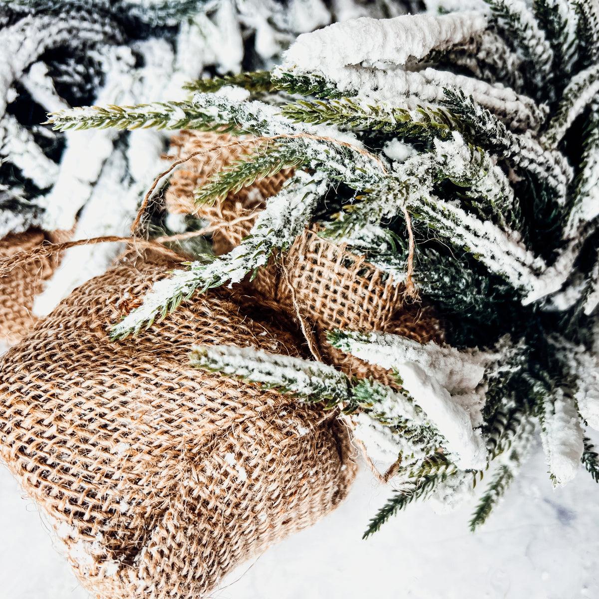Elegant neutral and white holiday decor featuring the realistic snow-covered tabletop trees.