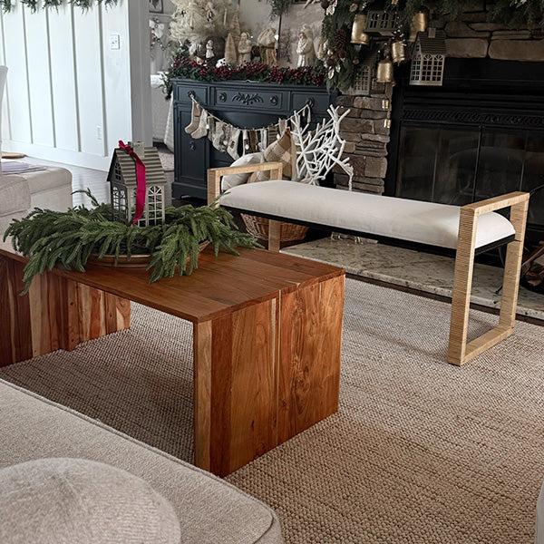 Living room with wooden coffee table, beige sofa, and decorative items.