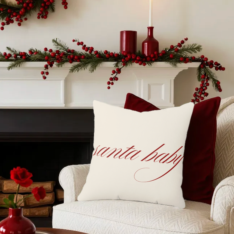 Decorative pillow with 'Santa Baby' text on a couch in a festive living room.