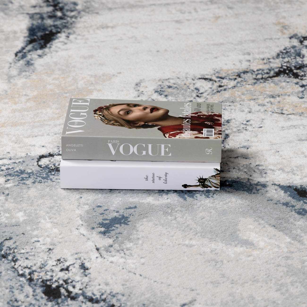 Close-up of the slate blue and navy tones blending into the gray background of the rug.