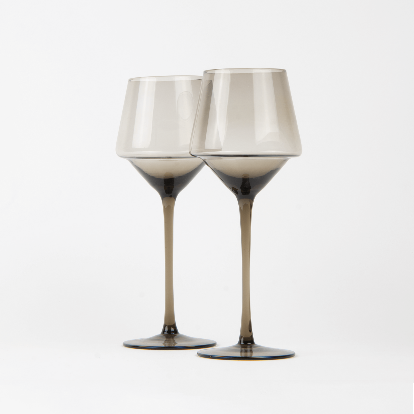 Two wine glasses with metallic accents on a white background