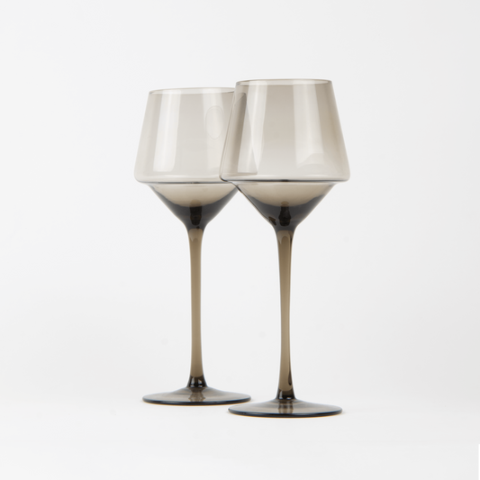 Two wine glasses with metallic accents on a white background