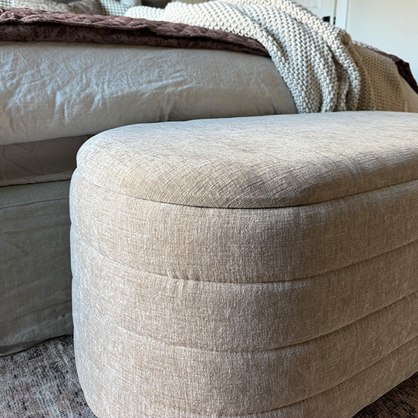 Neutral upholstered storage benches placed in entryway for clutter-free organization.