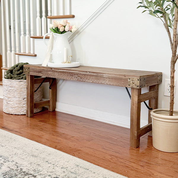 Vintage-inspired reclaimed wood folding bench displayed in a styled room