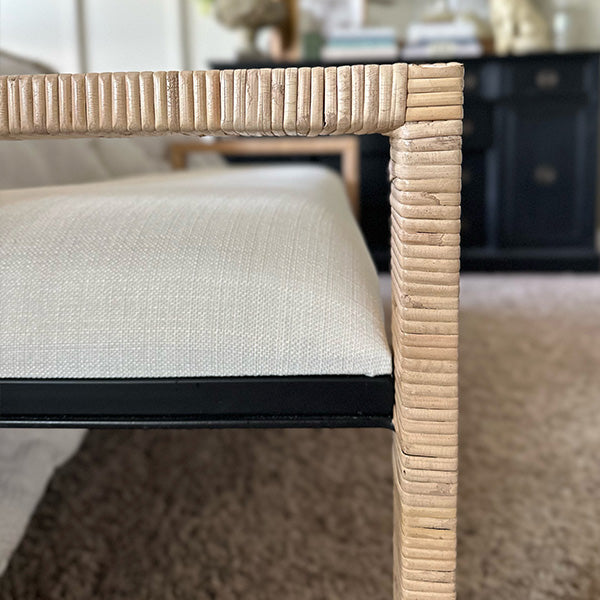 Handwoven rattan coastal bench styled in airy home décor